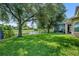 Scenic backyard overlooking a tranquil lake with a screened patio, and plenty of green space at 369 Torgiano Dr, Ocoee, FL 34761