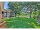 Backyard with a view of a lake, a screened patio and manicured lawn at 369 Torgiano Dr, Ocoee, FL 34761