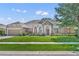 Charming single-story home with manicured lawn, stone accents, red door, and lush landscaping at 369 Torgiano Dr, Ocoee, FL 34761