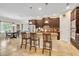 Spacious kitchen features an island with bar seating and elegant pendant lighting at 369 Torgiano Dr, Ocoee, FL 34761