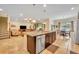 Open kitchen with island and stainless steel appliances flowing into the living space at 369 Torgiano Dr, Ocoee, FL 34761