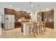 Spacious kitchen with stainless steel appliances, dark wood cabinets, and center island seating at 369 Torgiano Dr, Ocoee, FL 34761