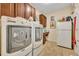 Spacious laundry room with washer, dryer, cabinets, and additional storage at 369 Torgiano Dr, Ocoee, FL 34761