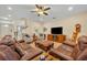 Spacious living room with a cozy fireplace and staircase to the upper level at 369 Torgiano Dr, Ocoee, FL 34761