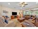 Comfortable living room featuring a decorative ceiling fan and sliding glass doors at 369 Torgiano Dr, Ocoee, FL 34761