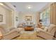 Cozy living room with neutral tones, plush seating, natural light, and elegant decor at 369 Torgiano Dr, Ocoee, FL 34761