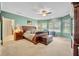 Spacious main bedroom with calming color palette, ceiling fan and large windows providing natural light at 369 Torgiano Dr, Ocoee, FL 34761