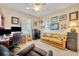Cozy home office with desk, sofa, and custom bookshelves at 369 Torgiano Dr, Ocoee, FL 34761
