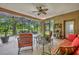 Screened patio with comfortable seating and lush backyard views overlooking the pond at 369 Torgiano Dr, Ocoee, FL 34761