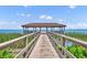 Waterfront pier featuring a covered gazebo and scenic views at 369 Torgiano Dr, Ocoee, FL 34761
