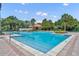 Community pool featuring multiple entry points, lounge chairs, and a clubhouse at 369 Torgiano Dr, Ocoee, FL 34761