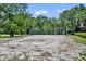Community sand volleyball court surrounded by lush greenery at 369 Torgiano Dr, Ocoee, FL 34761