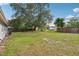 A spacious backyard featuring lush green grass and mature trees, perfect for outdoor enjoyment at 384 Zinnia Dr, Casselberry, FL 32707