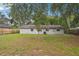 A spacious backyard featuring a lush green lawn and the back of the building at 384 Zinnia Dr, Casselberry, FL 32707