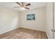 Bright bedroom featuring modern ceiling fan, wood-look flooring, and natural light from the window at 384 Zinnia Dr, Casselberry, FL 32707