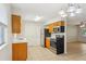 Kitchen with stainless appliances, tile floor, wood cabinets and breakfast nook at 384 Zinnia Dr, Casselberry, FL 32707