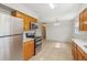 Kitchen with stainless steel appliances, tile floors, and adjacent dining area at 384 Zinnia Dr, Casselberry, FL 32707