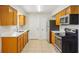 Traditional kitchen featuring tile flooring, updated appliances, and bright lighting at 384 Zinnia Dr, Casselberry, FL 32707