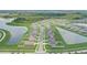 Picturesque aerial view of a residential community with winding roads, scenic ponds, and lush landscaping at 392 Citrine Loop, Kissimmee, FL 34758