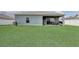 Spacious backyard featuring a well-maintained lawn and patio area, perfect for outdoor entertaining at 392 Citrine Loop, Kissimmee, FL 34758