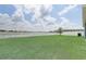 Backyard featuring a lush lawn with a white picket fence at 392 Citrine Loop, Kissimmee, FL 34758