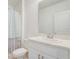 Well-lit bathroom featuring a vanity and a shower with curtain at 392 Citrine Loop, Kissimmee, FL 34758