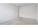 A well-lit bedroom with neutral carpeting, white walls, and a closet at 392 Citrine Loop, Kissimmee, FL 34758