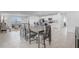 Open-concept dining area featuring a table for six, flowing seamlessly into the modern kitchen and living space at 392 Citrine Loop, Kissimmee, FL 34758