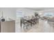 Bright dining area features a table for six adjacent to a living area with neutral tones and natural light at 392 Citrine Loop, Kissimmee, FL 34758