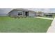 Well-kept home with green lawn, and a two-car garage at 392 Citrine Loop, Kissimmee, FL 34758