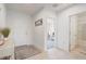 Bright foyer with tile flooring, a welcome sign, and views into other rooms at 392 Citrine Loop, Kissimmee, FL 34758