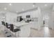 Modern kitchen featuring white cabinets, a kitchen island with seating, and stainless steel appliances at 392 Citrine Loop, Kissimmee, FL 34758