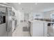 Open kitchen featuring white cabinets, stainless steel appliances, and an island with a sink at 392 Citrine Loop, Kissimmee, FL 34758