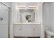 Well-lit main bathroom featuring a double vanity, modern fixtures, and a glass-enclosed shower at 392 Citrine Loop, Kissimmee, FL 34758