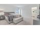 Serene main bedroom with neutral tones, a king-size bed, and an ensuite bathroom for added convenience at 392 Citrine Loop, Kissimmee, FL 34758