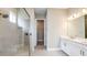 Bathroom boasts double sinks, white cabinets, walk-in shower, and a view to the walk-in closet at 4209 Barbuda Ln, Kissimmee, FL 34758