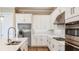 Well-appointed kitchen with stainless steel appliances, white cabinets, and a central island at 4209 Barbuda Ln, Kissimmee, FL 34758