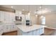 Gourmet kitchen with stainless steel appliances, quartz countertops, and an island at 4209 Barbuda Ln, Kissimmee, FL 34758