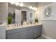Bright bathroom with double sinks, stylish decor, a large mirror, and lots of counter space at 4215 Barbuda Ln, Kissimmee, FL 34758