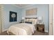 Cozy bedroom features blue walls, stylish decor, a comfortable bed, and soft lighting at 4215 Barbuda Ln, Kissimmee, FL 34758