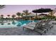 Beautiful community pool with lounge chairs, sun umbrellas, and the Bahama Bar at 4215 Barbuda Ln, Kissimmee, FL 34758