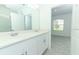 Bathroom features dual sinks, vanity, and large mirror at 491 Wayland Dr, Haines City, FL 33844