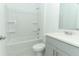 Clean, well-lit bathroom with shower-tub combo and gray vanity at 491 Wayland Dr, Haines City, FL 33844