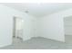 Neutral bedroom with carpet and doorways to bathroom and another room at 491 Wayland Dr, Haines City, FL 33844