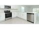 Modern kitchen featuring stainless steel appliances, white cabinets, and a center island with sink at 491 Wayland Dr, Haines City, FL 33844