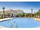 Beautiful pool surrounded by lounge chairs and umbrellas, perfect for relaxation on a sunny day at 491 Wayland Dr, Haines City, FL 33844
