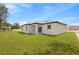 Backyard with healthy lawn and covered patio space, perfect for outdoor entertaining at 508 Churchill Pl, Poinciana, FL 34759