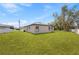 Spacious backyard featuring a well-maintained lawn and views of the home's rear exterior at 508 Churchill Pl, Poinciana, FL 34759