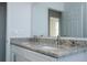 Modern bathroom featuring a double sink with granite countertops and sleek fixtures at 508 Churchill Pl, Poinciana, FL 34759