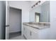 Bright bathroom vanity with double sinks, a long mirror, and brushed metal fixtures at 508 Churchill Pl, Poinciana, FL 34759